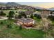 An aerial view of a house on a verdant lot in a mountain community at 6491 Crestbrook Dr, Morrison, CO 80465