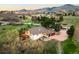 Aerial view showcases the landscaped property and mountain views at 6491 Crestbrook Dr, Morrison, CO 80465