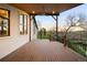 Spacious back deck featuring wood-plank flooring, scenic views, and an exposed wood ceiling at 6491 Crestbrook Dr, Morrison, CO 80465