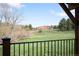 Wooden back deck overlooking a lush lawn and rocky hills at 6491 Crestbrook Dr, Morrison, CO 80465