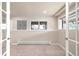 Basement room features neutral carpet, a window, and an access door to another room at 6491 Crestbrook Dr, Morrison, CO 80465