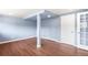 Unfinished basement area with painted columns, a full sized window, and an access door at 6491 Crestbrook Dr, Morrison, CO 80465