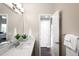 Bright bathroom features a modern vanity with stone counters, contemporary lighting, and neutral wall color at 6491 Crestbrook Dr, Morrison, CO 80465