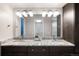 Bathroom featuring double sinks, granite countertop, and updated lighting at 6491 Crestbrook Dr, Morrison, CO 80465