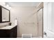 Neutral bathroom features a stone countertop, a dark wood vanity, and a walk-in shower at 6491 Crestbrook Dr, Morrison, CO 80465