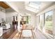 Bright dining area with skylights and large windows overlooking the backyard at 6491 Crestbrook Dr, Morrison, CO 80465