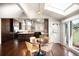 Open dining area with modern light fixture adjacent to the kitchen at 6491 Crestbrook Dr, Morrison, CO 80465