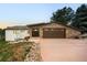 Lovely house with a stone facade two-car garage, and a pink colored driveway at 6491 Crestbrook Dr, Morrison, CO 80465