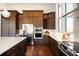 Gourmet kitchen features stainless appliances, wine rack, and island with marble countertop at 6491 Crestbrook Dr, Morrison, CO 80465