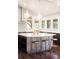 Modern kitchen with island, bar stools, and stainless steel appliances at 6491 Crestbrook Dr, Morrison, CO 80465