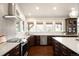 Elegant kitchen features stainless steel appliances, white countertops, and ample cabinet space at 6491 Crestbrook Dr, Morrison, CO 80465