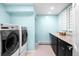 Bright laundry room features new washer and dryer units and ample storage space at 6491 Crestbrook Dr, Morrison, CO 80465