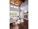 Bright living room with a stone fireplace, hardwood floors, and backyard views at 6491 Crestbrook Dr, Morrison, CO 80465