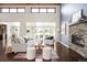 Bright living room with stone fireplace, hardwood floors, and backyard views at 6491 Crestbrook Dr, Morrison, CO 80465