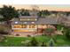 Stunning rear view of home with deck and floor-to-ceiling windows at 6491 Crestbrook Dr, Morrison, CO 80465