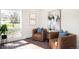 Cozy sitting room featuring brick floors, accent chairs and natural light at 6491 Crestbrook Dr, Morrison, CO 80465