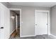 This bedroom features neutral walls, gray carpet, a closet, and a doorway at 808 Hanover St, Aurora, CO 80010