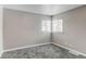 This bedroom features neutral walls, gray carpet, and bright windows, creating a cozy and inviting space at 808 Hanover St, Aurora, CO 80010