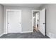 This bedroom features neutral walls, gray carpet, a closet, and a doorway at 808 Hanover St, Aurora, CO 80010