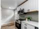 Modern kitchen featuring stainless steel appliances, white cabinets, and attractive backsplash at 808 Hanover St, Aurora, CO 80010