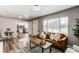 Bright living room featuring a stylish leather sofa with an open view to the renovated kitchen area at 808 Hanover St, Aurora, CO 80010