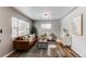 Inviting living room featuring a stylish brown leather sofa, neutral decor, and an abundance of natural light at 808 Hanover St, Aurora, CO 80010