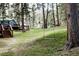Serene backyard with a charming tree swing, surrounded by lush greenery and mature trees at 29101 Drexel Spur, Evergreen, CO 80439