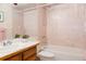 Compact bathroom featuring a vanity, toilet and bathtub/shower with tile surround at 29101 Drexel Spur, Evergreen, CO 80439