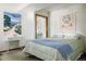 Well-lit bedroom featuring a white writing desk, a queen bed, and light green walls at 29101 Drexel Spur, Evergreen, CO 80439