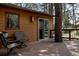 Cozy deck with chairs, offering a peaceful outdoor retreat amidst lush trees at 29101 Drexel Spur, Evergreen, CO 80439