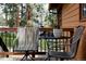 Tranquil outdoor seating on the deck, offering a cozy spot to unwind and appreciate the natural beauty at 29101 Drexel Spur, Evergreen, CO 80439