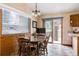 Charming dining area featuring a wood table and chairs, natural light, and access to the outdoors at 29101 Drexel Spur, Evergreen, CO 80439