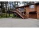 Two story home featuring an elevated deck, a wooden staircase, and an attached garage at 29101 Drexel Spur, Evergreen, CO 80439