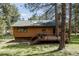 Charming home with a lovely deck, nestled among mature trees and a beautifully landscaped yard at 29101 Drexel Spur, Evergreen, CO 80439