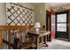 Hallway with a decorative quilt, warm lighting, and an eye-catching, red entryway door at 29101 Drexel Spur, Evergreen, CO 80439