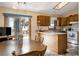 Eat in kitchen featuring wood cabinetry, stone countertops, and a sliding glass door to a patio at 29101 Drexel Spur, Evergreen, CO 80439