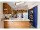 Bright kitchen with wooden cabinets, a skylight, ample counter space, and modern appliances at 29101 Drexel Spur, Evergreen, CO 80439
