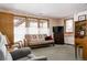 Relaxing living room features a cozy futon, large windows with bright light, and carpeted floors at 29101 Drexel Spur, Evergreen, CO 80439