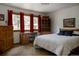 Inviting bedroom with wood furniture, bright windows, and a serene atmosphere for relaxation at 29101 Drexel Spur, Evergreen, CO 80439