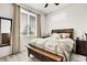 Comfortable bedroom featuring a king-sized bed, two large windows, and a ceiling fan at 12258 Hazel Spruce Ct, Parker, CO 80134