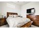Inviting bedroom with a comfortable king bed, two side tables, and a dresser with a TV at 12258 Hazel Spruce Ct, Parker, CO 80134