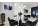 Elegant dining area showcasing a glass table, modern chandelier, and sophisticated decor at 12258 Hazel Spruce Ct, Parker, CO 80134