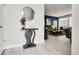 Stylish entryway with console table and mirror, opening to a spacious living area at 12258 Hazel Spruce Ct, Parker, CO 80134