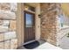 Inviting front door with decorative glass, set within a stone-accented entryway at 12258 Hazel Spruce Ct, Parker, CO 80134