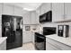 Well-equipped kitchen with black appliances, ample counter space and gray cabinets at 12258 Hazel Spruce Ct, Parker, CO 80134