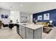 Bright, open floor plan kitchen with large island and seamless flow into the living area at 12258 Hazel Spruce Ct, Parker, CO 80134