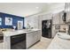 Modern kitchen featuring stainless steel appliances, granite countertops, and gray cabinets at 12258 Hazel Spruce Ct, Parker, CO 80134