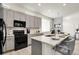 Bright kitchen featuring a spacious island with counter seating and stainless steel appliances at 12258 Hazel Spruce Ct, Parker, CO 80134