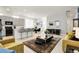 Open-concept layout with bar seating, connecting living area with sleek furnishings at 12258 Hazel Spruce Ct, Parker, CO 80134