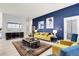 Bright living room showcasing a striking blue accent wall and modern furnishings at 12258 Hazel Spruce Ct, Parker, CO 80134